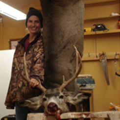 Woman Standing Beside a Deer