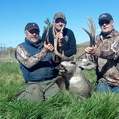 Group of Hunters with Deer